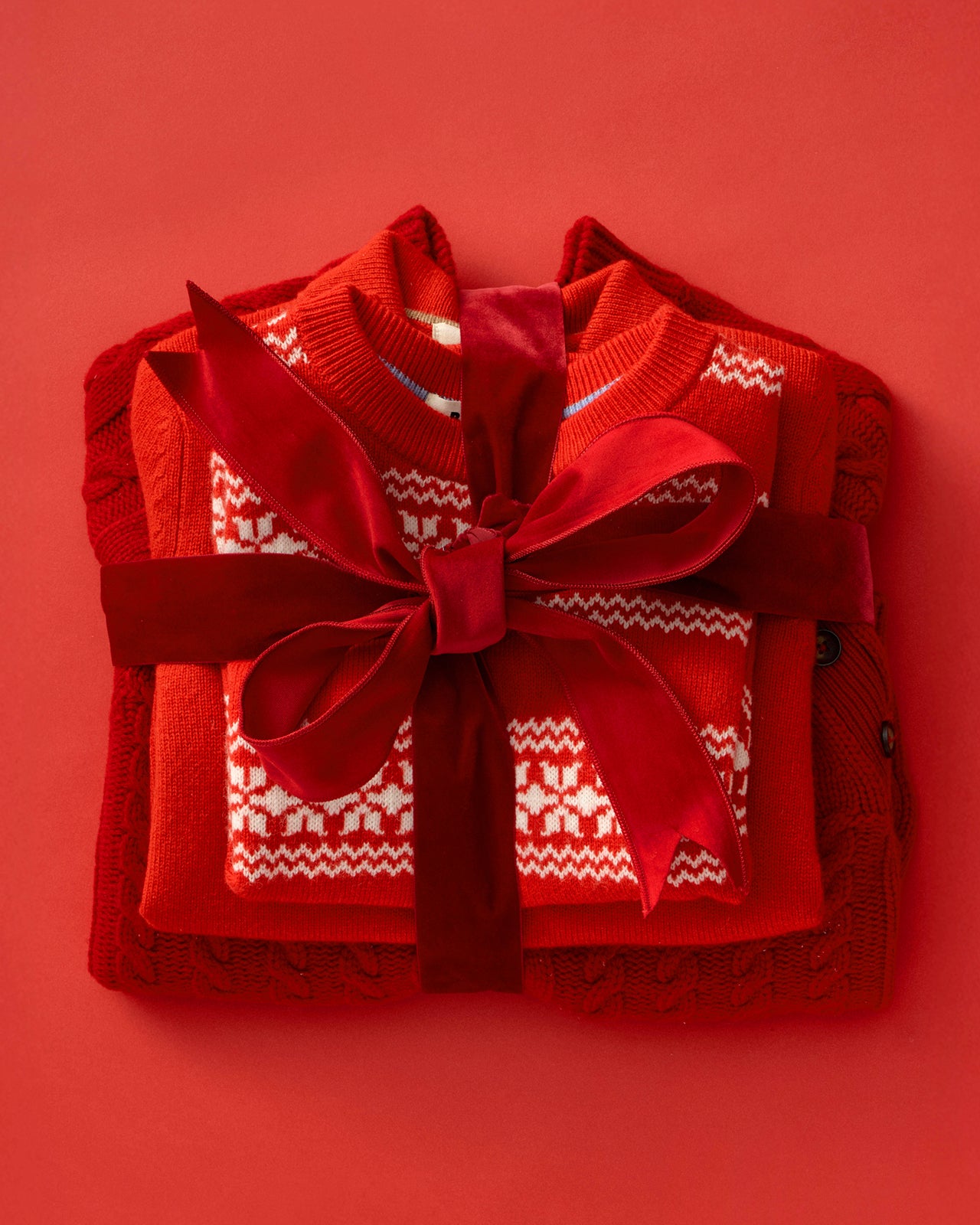 Red sweater with a large bow on a red background
