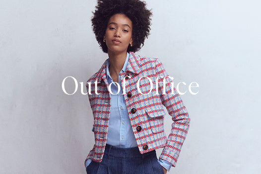 Woman wearing a patterned jacket with text 'Out of Office' on a plain background