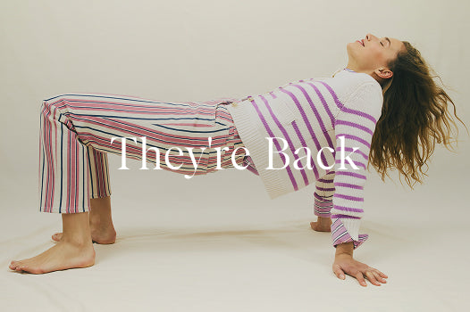 Person lying on their back with striped pajama pants and a blanket, text 'They're Back' overlayed.