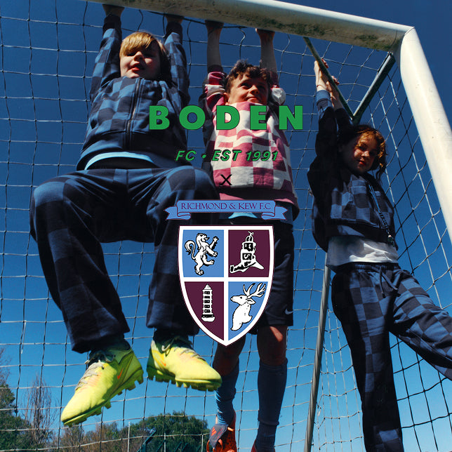 Three children playing on a soccer goal with 'Boden FC' branding and a crest.