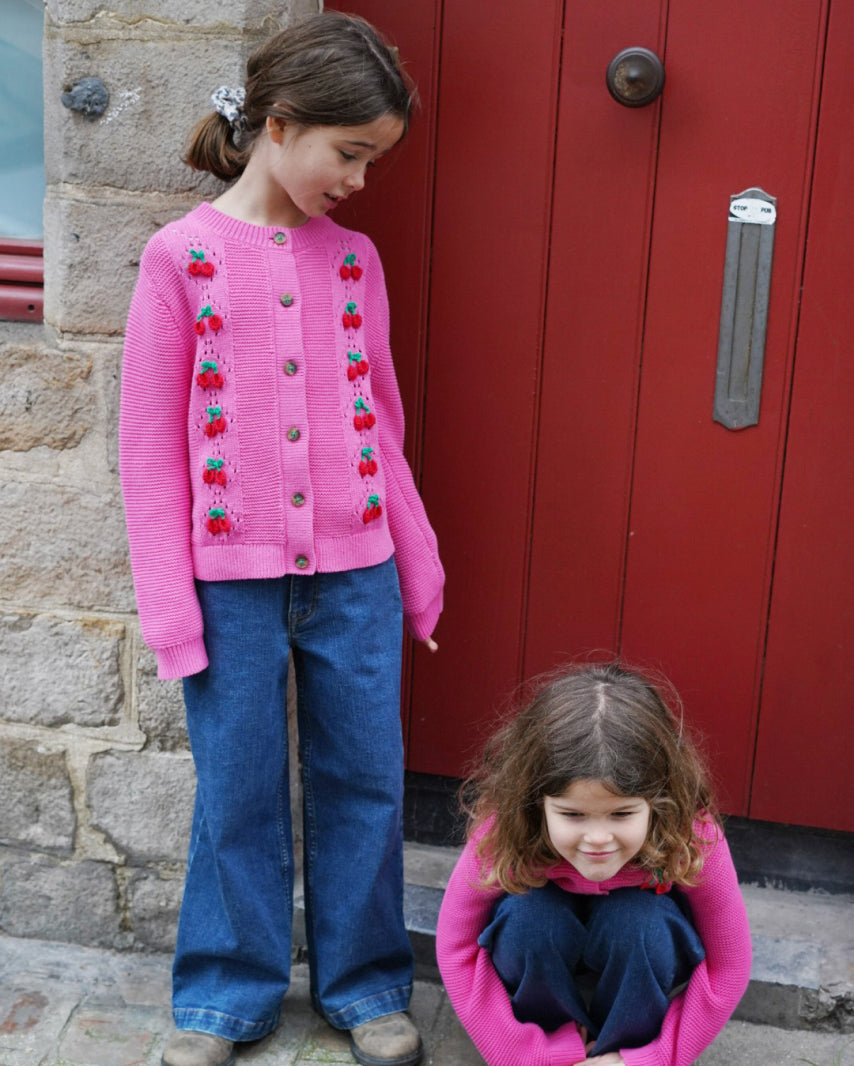 Two girls wearing matching Boden knit