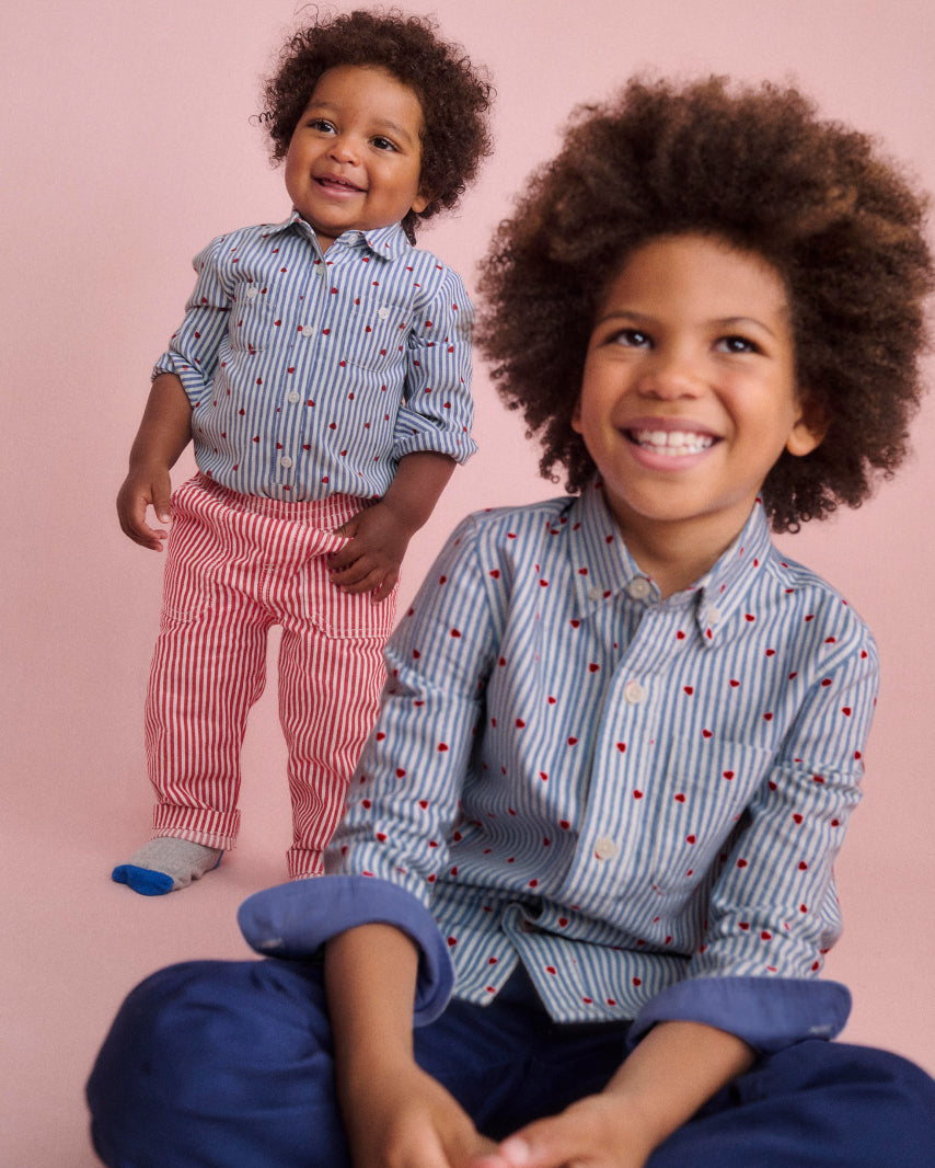 Two baby boden models wearing matching boyswear boden shirts