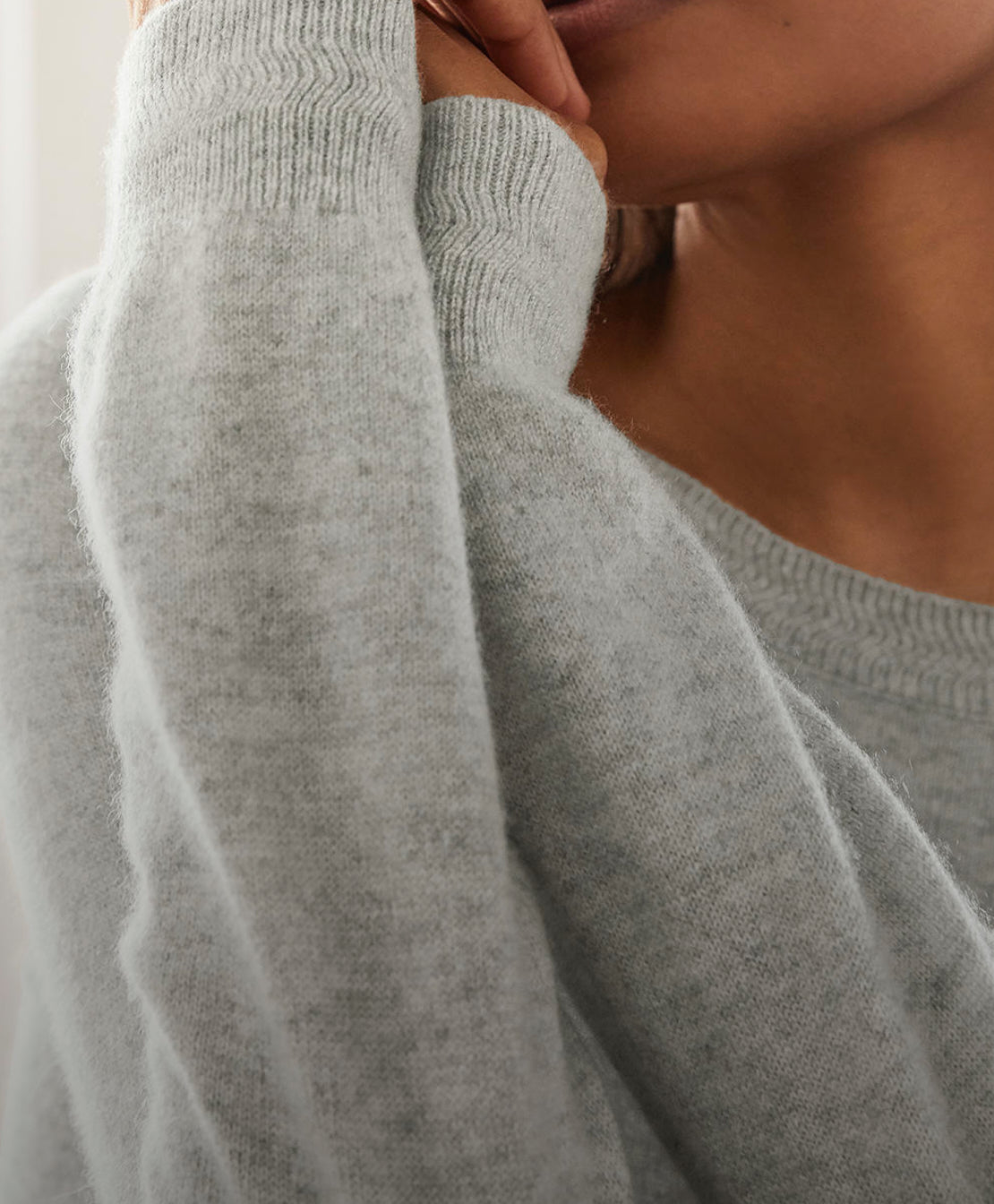 Close up of woman wearing grey cashmere jumper