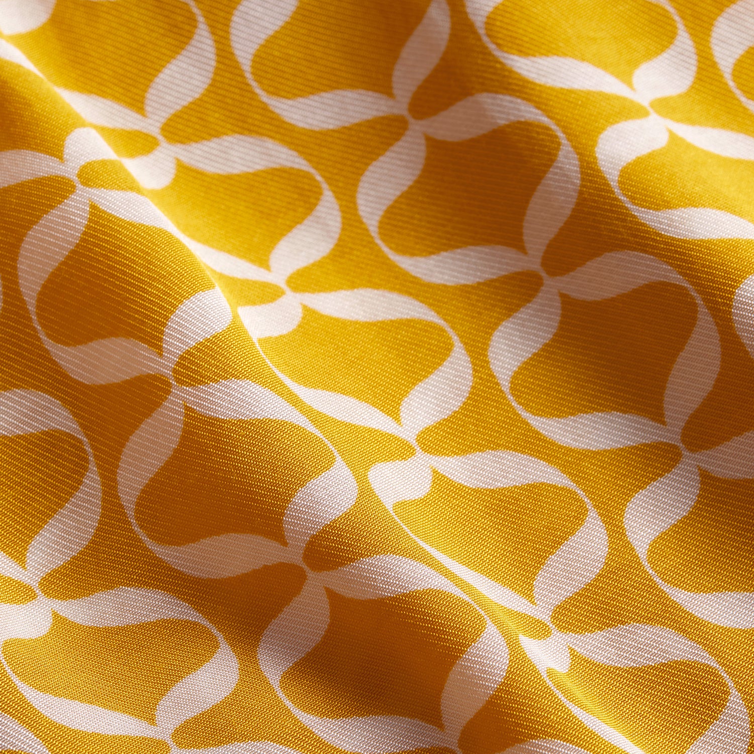 Close up of yellow and white patterned viscose cloth