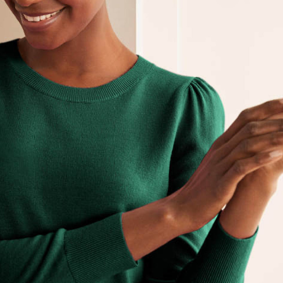 Close up of woman wearing green wool jumper